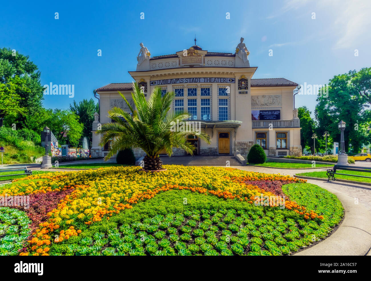 Austria, Carinthia, Klagenfurt, Stadttheater Klagenfurt with flowerbed in foreground Stock Photo