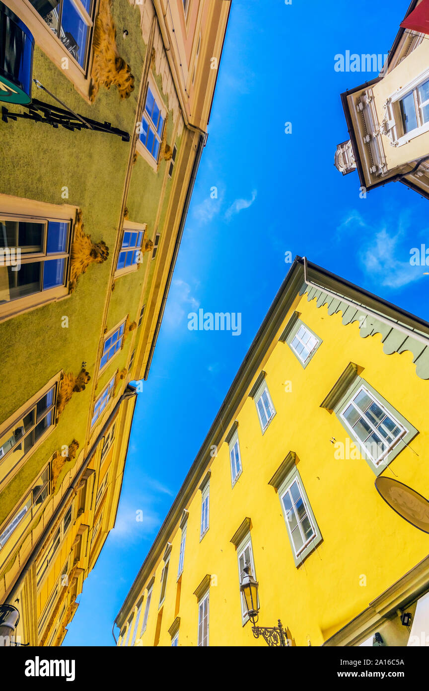 Austria, Carinthia, Klagenfurt am Worthersee, Low angle view of old yellow buildings on sunny day Stock Photo