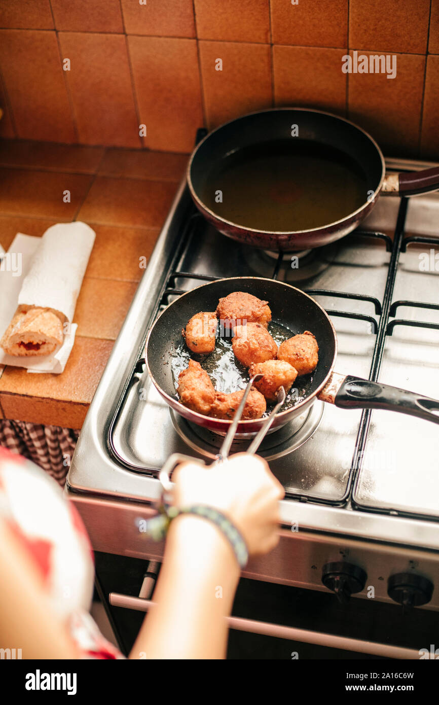 Close-up of a woman cooking croquettes in a pan Stock Photo