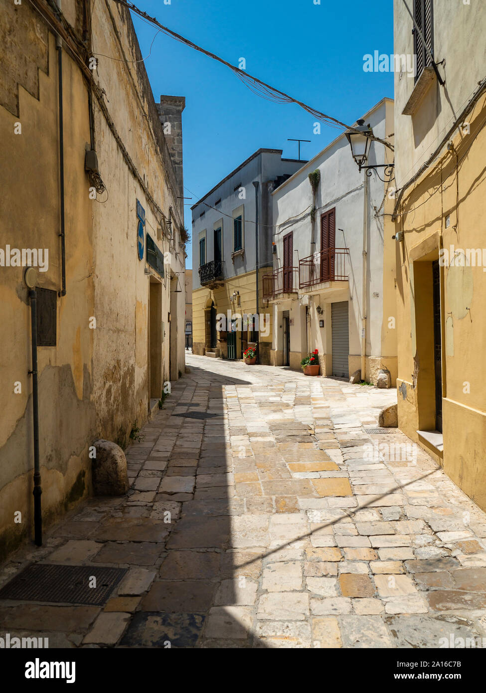 Empty alley amidst buildings in old town on sunny day Stock Photo