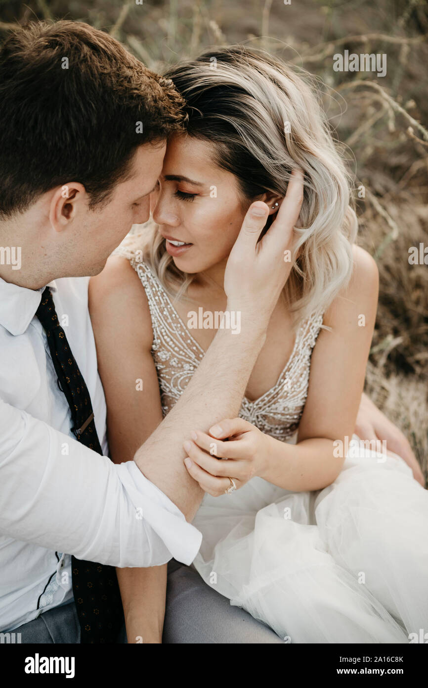 Bride and groom sitting hi-res stock photography and images - Alamy