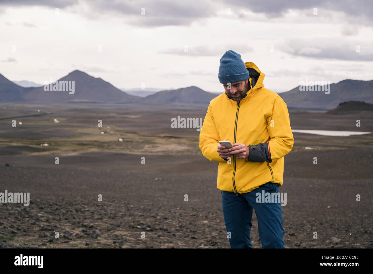 Mature man using smartphone in the Icelandic highlands Stock Photo