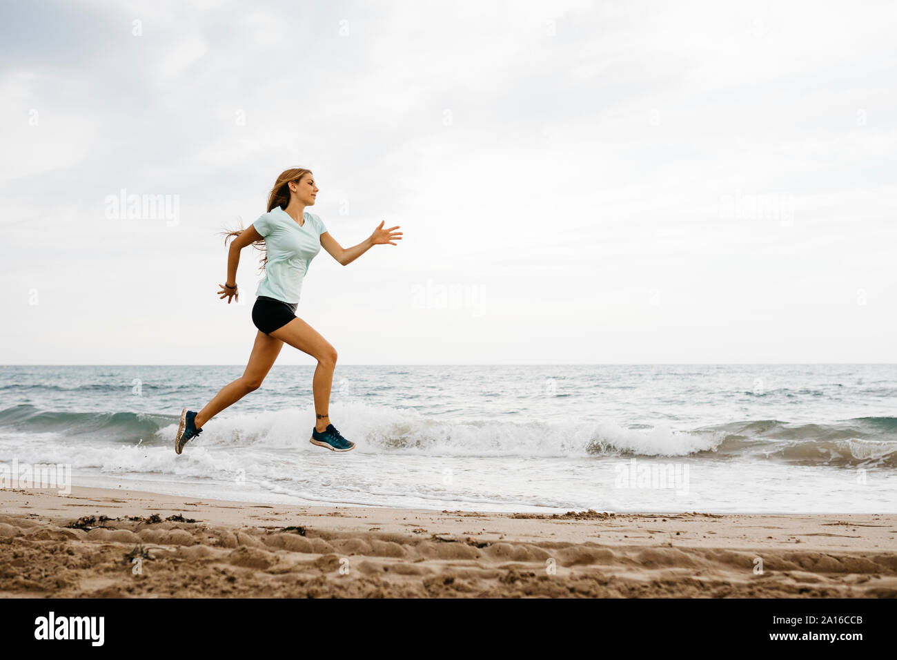 Female jogger at the beach Stock Photo