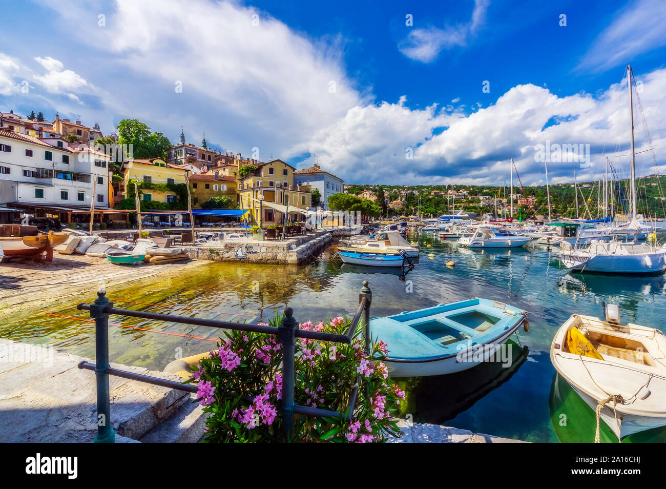 Sailboats moored at Opatija coast against sky Stock Photo