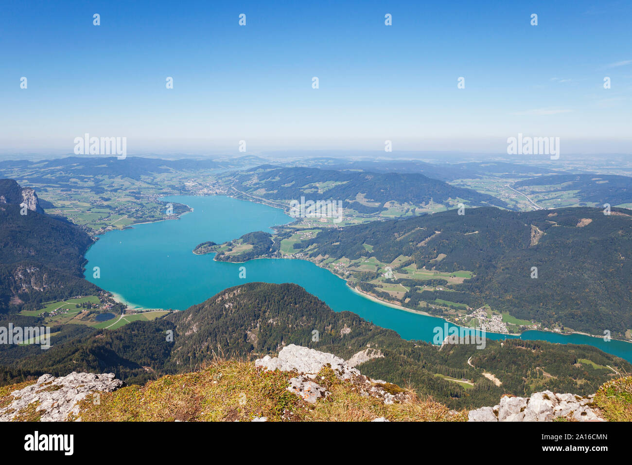 Idyllic shot of lake and mountains against blue sky Stock Photo