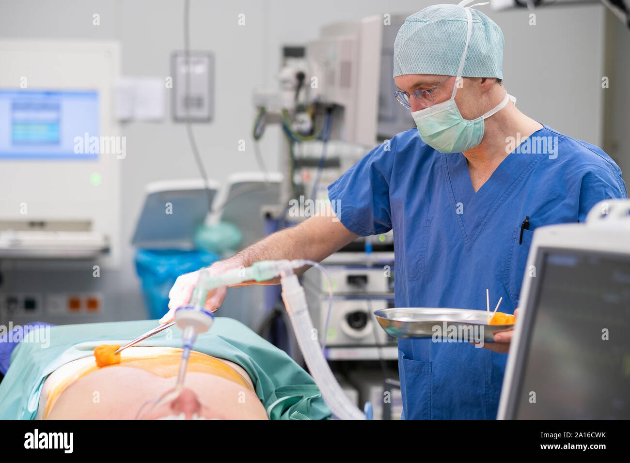 Surgeon during surgery, disinfecting Stock Photo