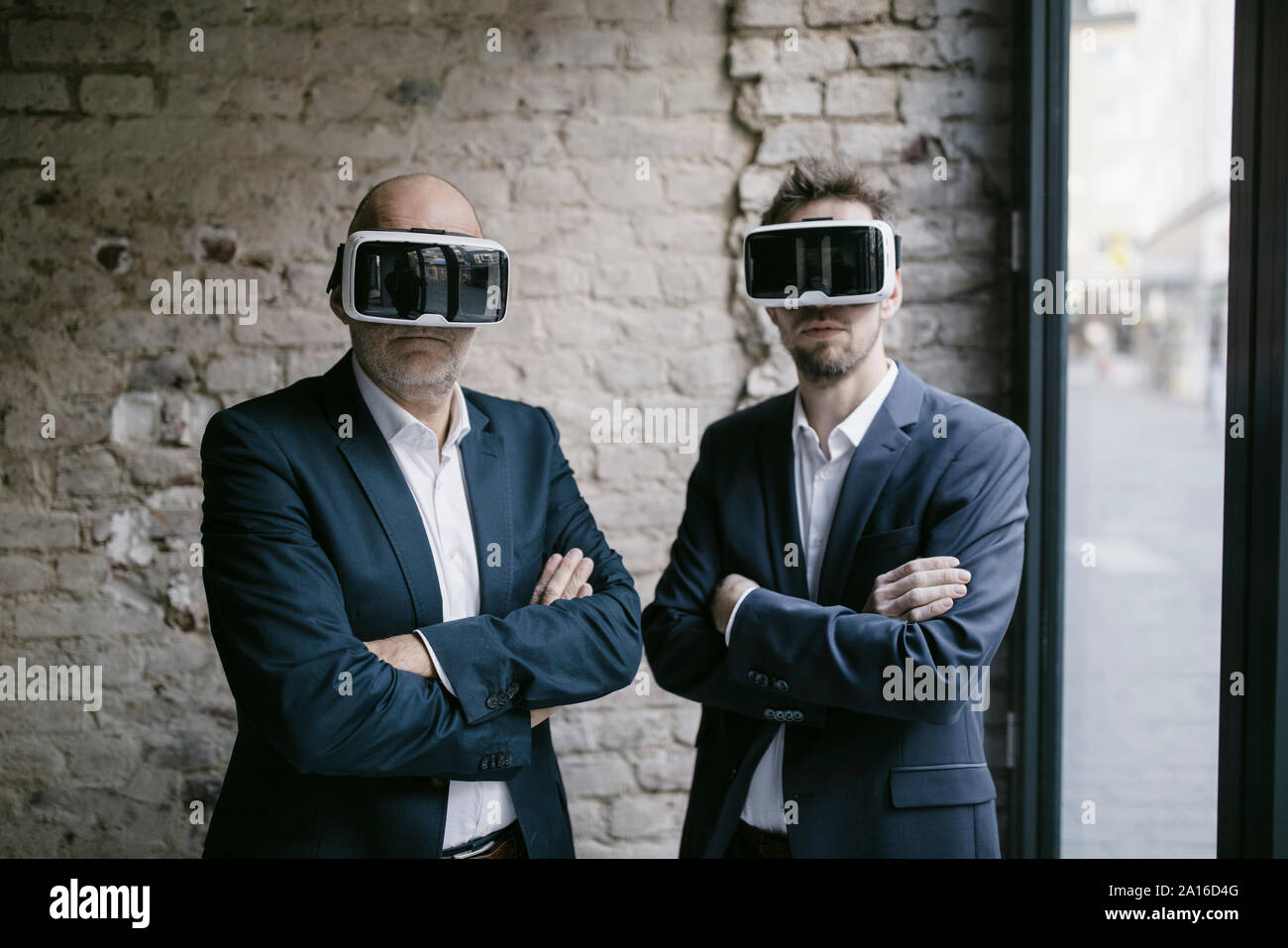 Senior and mid-adult businessman wearing VR glasses Stock Photo - Alamy