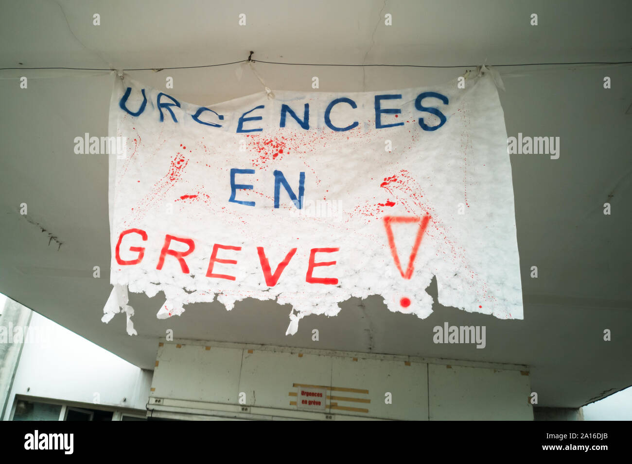 Urgences en greve (meaning medical emergency on strike in French) written on a used banner in France Stock Photo