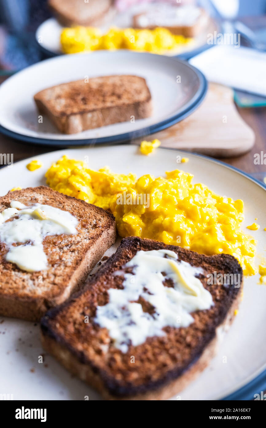 Fresh organic eggs, scrambled, with home made wholemeal bread for breakfast UK Stock Photo