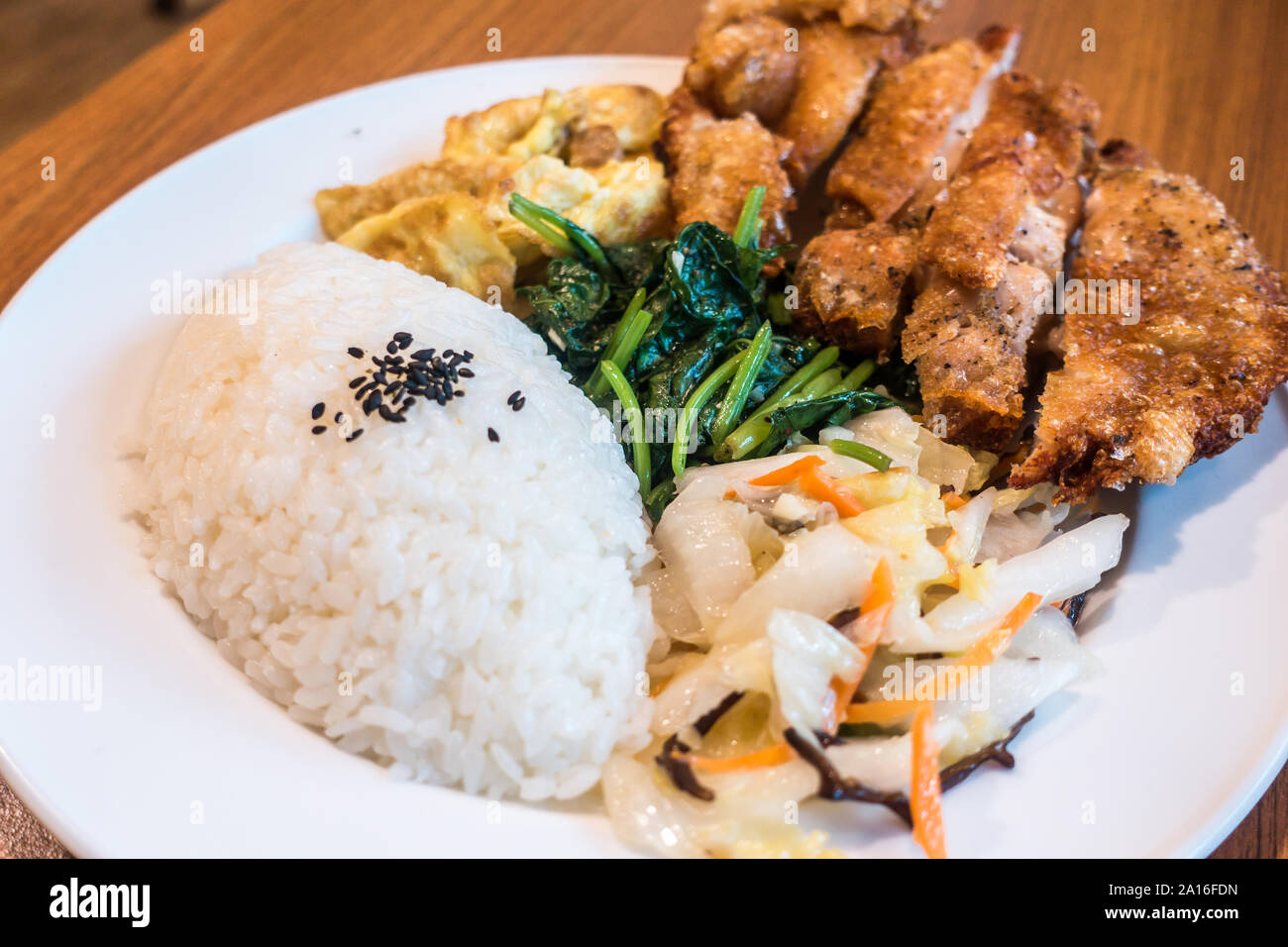 Taiwanese food gourmet fried chicken with rice , bento/boxed meal in wood background Stock Photo