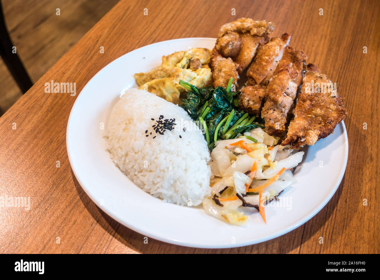 Taiwanese food gourmet fried chicken with rice , bento/boxed meal in wood background Stock Photo