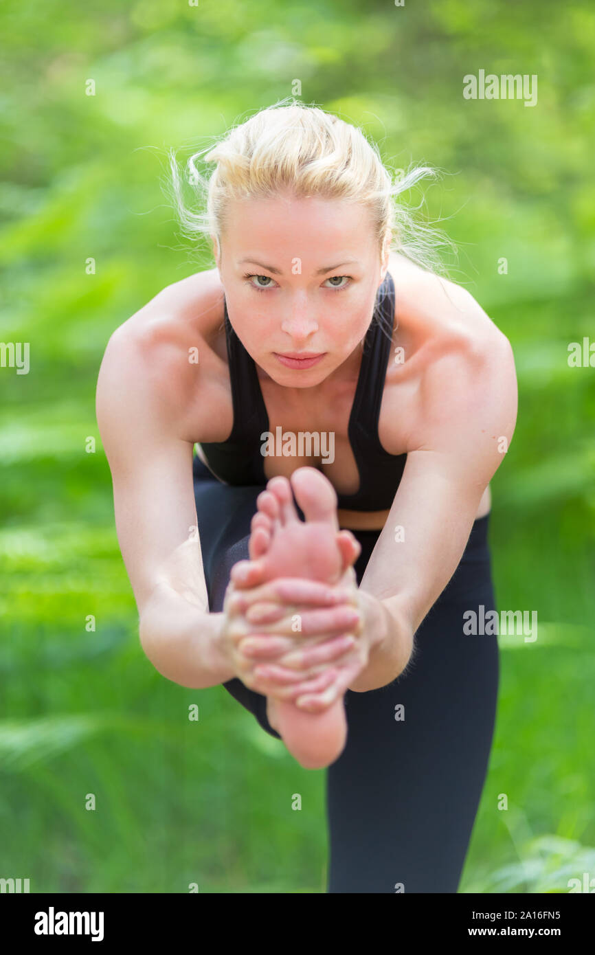 Lady practicing yoga in the nature. Stock Photo