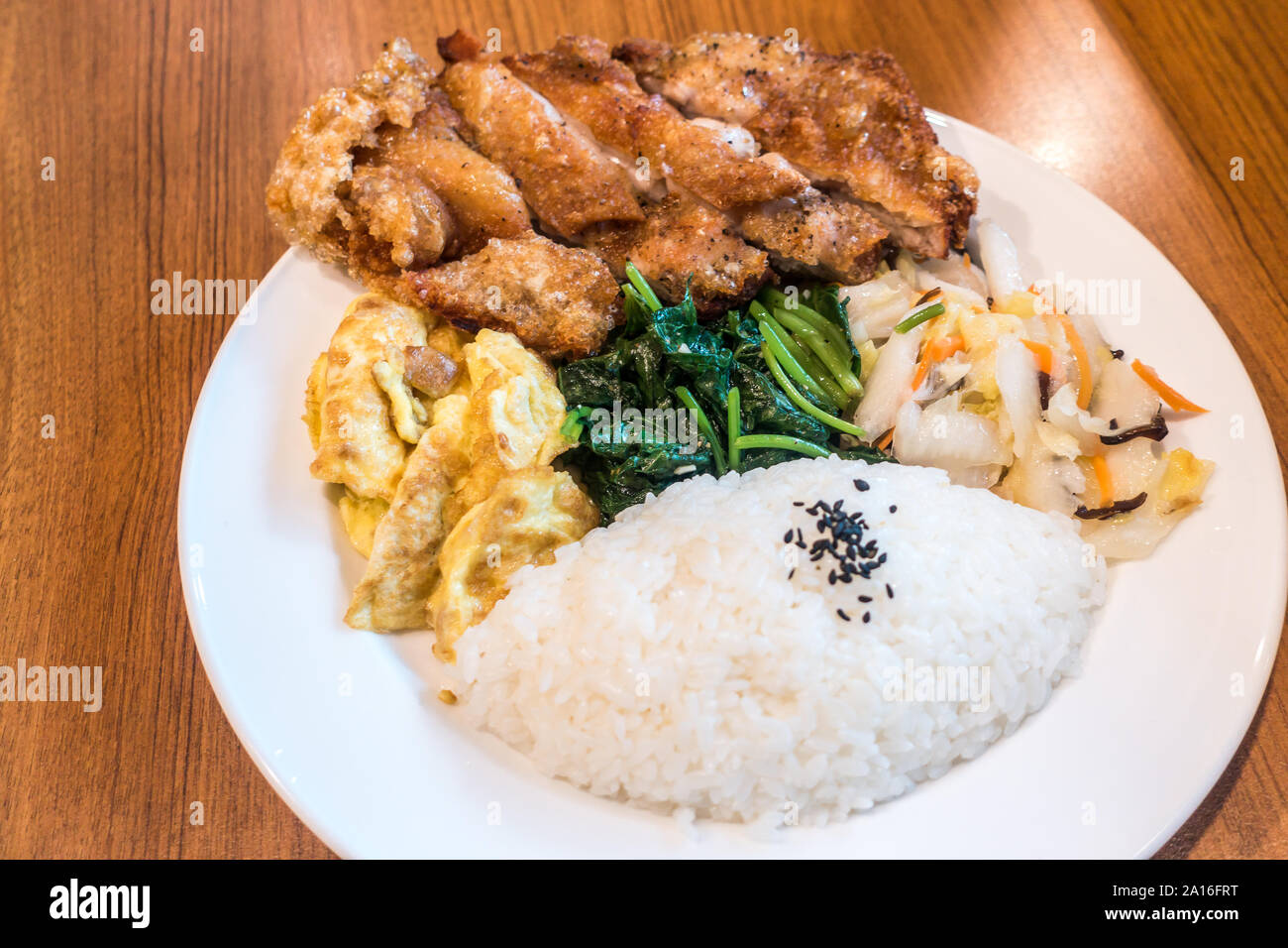 Taiwanese food gourmet fried chicken with rice , bento/boxed meal in wood background Stock Photo