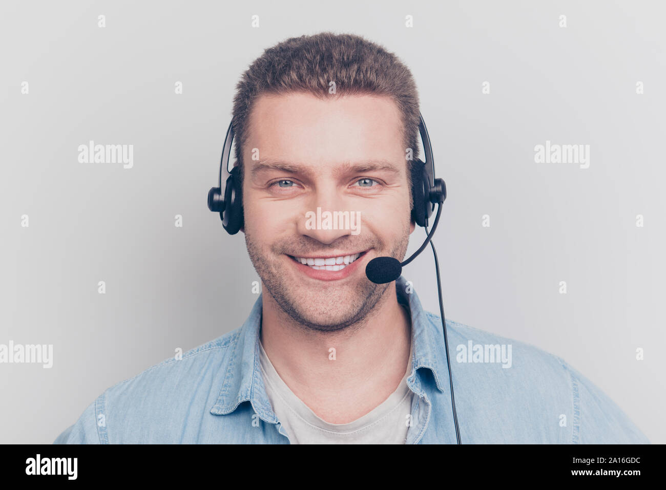 Cheerful glad positive kind assistance man having headset with m Stock Photo