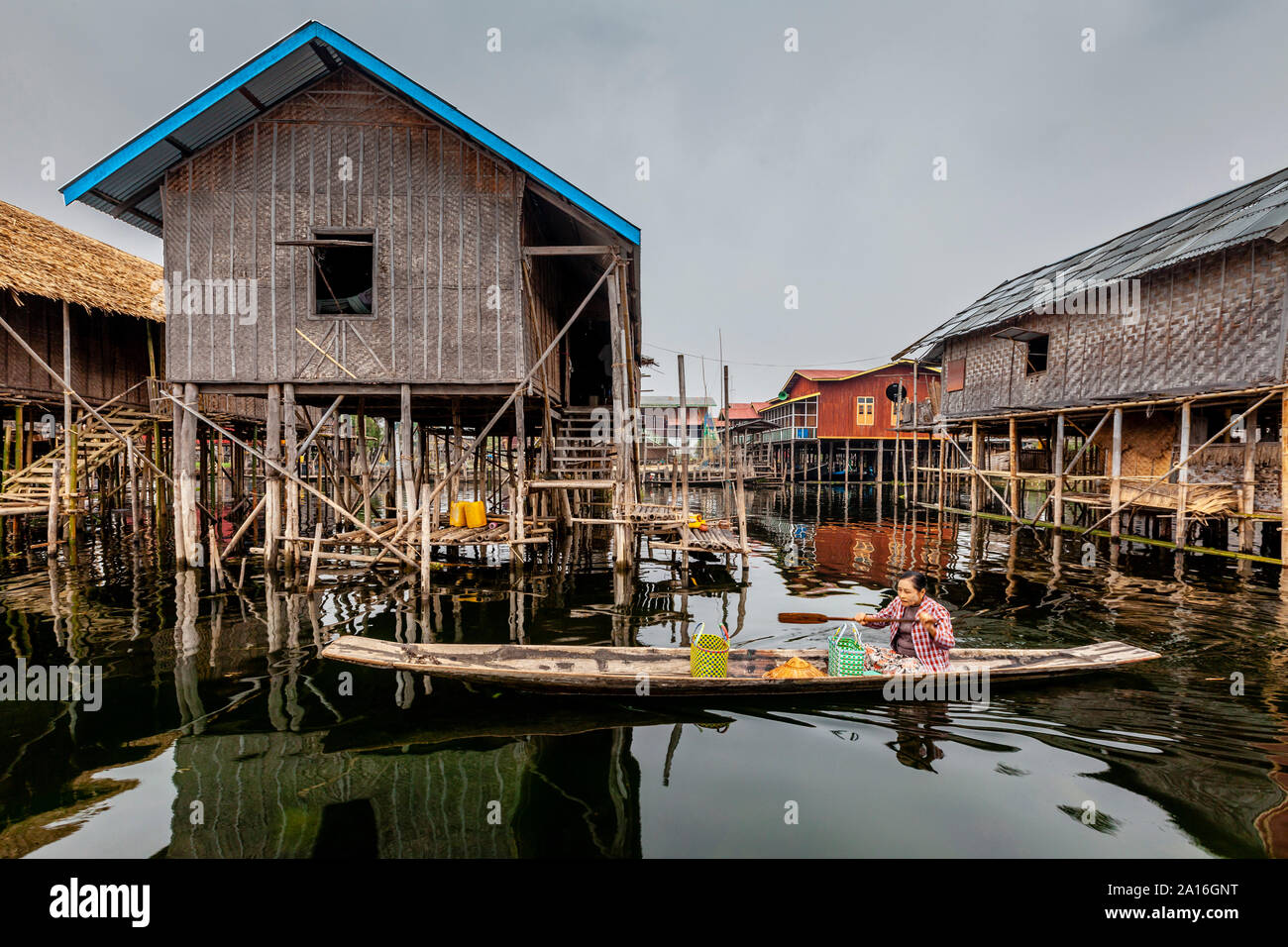 An Elderly Local Woman Getting Around Nampan Village By Boat, Lake Inle, Shan State, Myanmar. Stock Photo