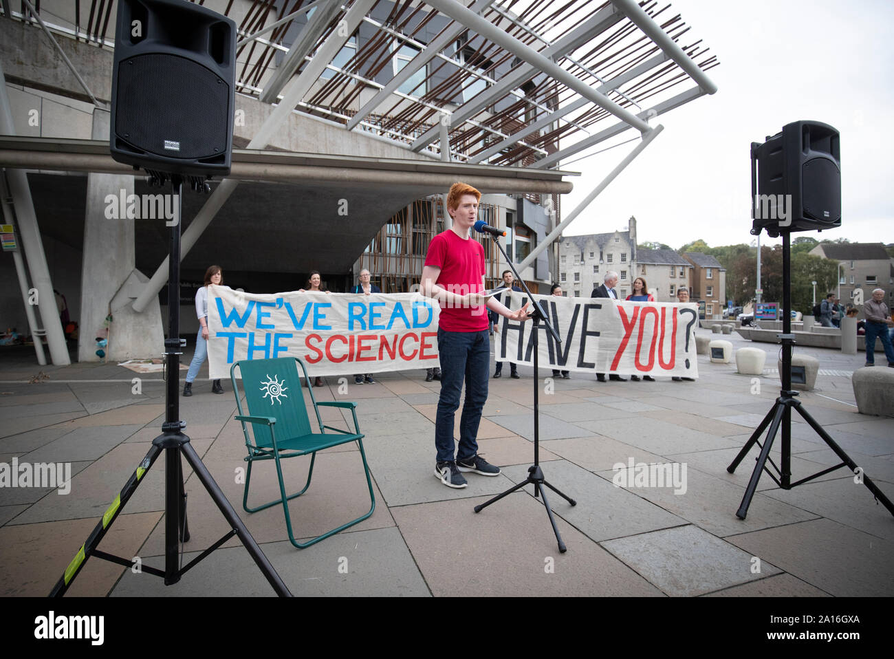 Sandy Boyd, from the Scottish Youth Climate Strike, outside the Scottish Parliament in Edinburgh ahead of MSPs casting their final vote on Scotland's new Climate Change Bill. Boyd read out the landmark UN IPCC Special Report on 1.5C that says action must increase urgently within the next decade. Stock Photo