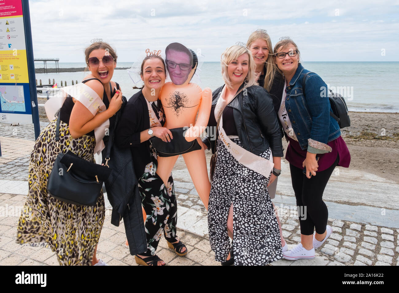A group of women on a hen party batchelorette party on the promenade in Aberystwyth on a summer afternoon, Wales UK Stock Photo
