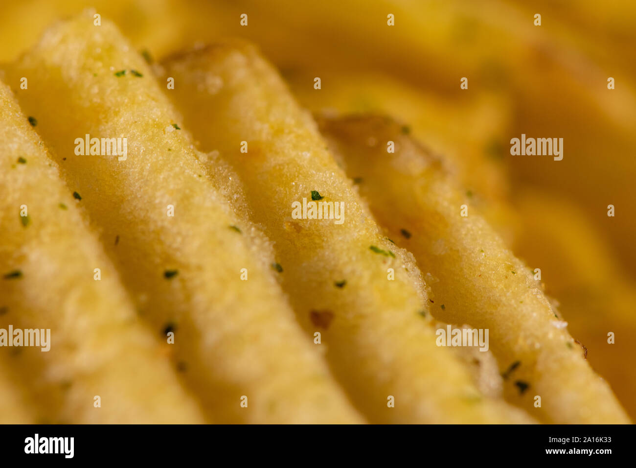 Macro photo of golden fried potato chips. Stock Photo