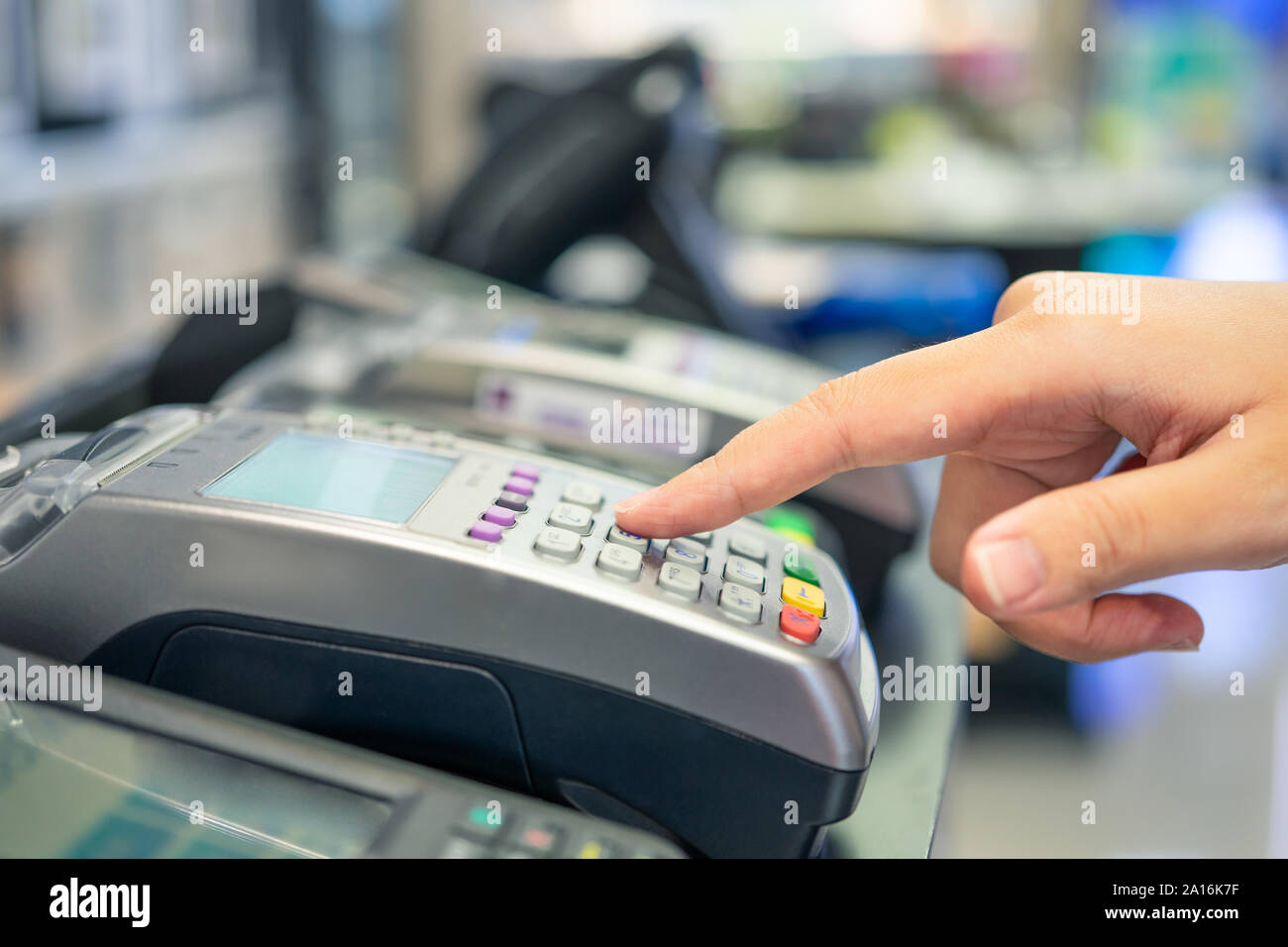 Credit Card Swipe Machine And A Young Woman Holding A Credit Card To Pay For Purchases Using Money From The Card Or Installment Payments Stock Photo Alamy