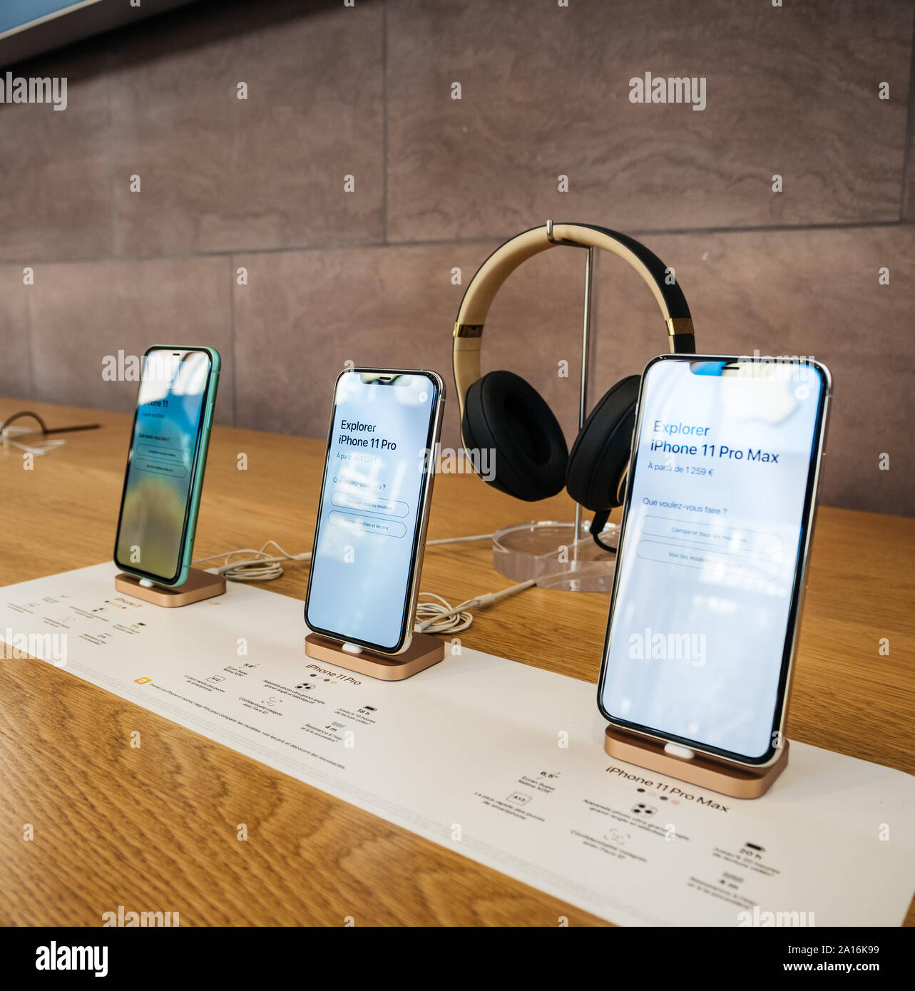 Paris, France - Sep 20, 2019: The new iPhone 11, 11 Pro and Pro Max range displayed in Apple Store next to Beats by Dr Dre Headphones - square image Stock Photo