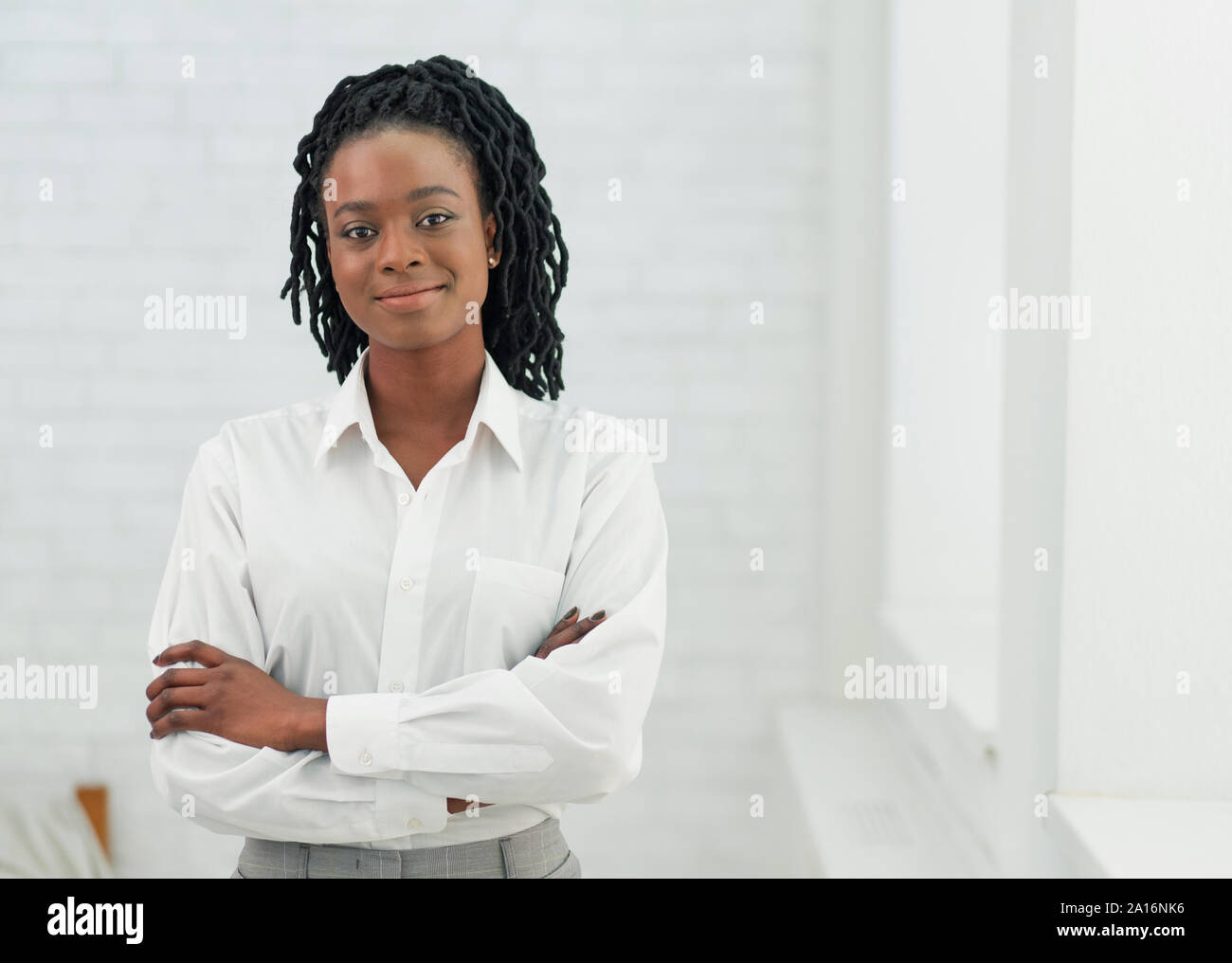 Positive African American Businesswoman Crossing Hands Standing, Indoor ...