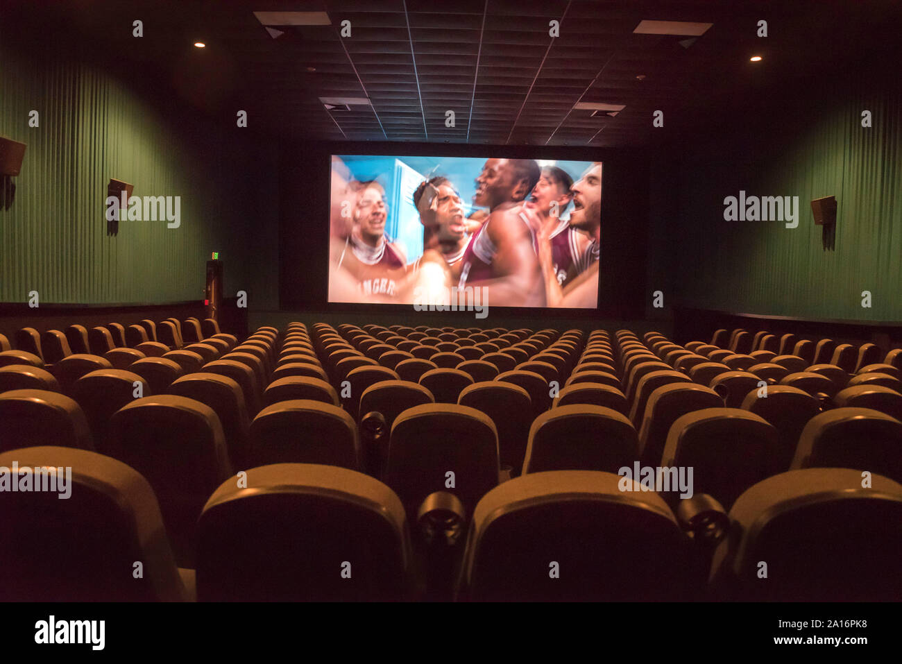 Movie theater interior showing screen and empty seats. Stock Photo