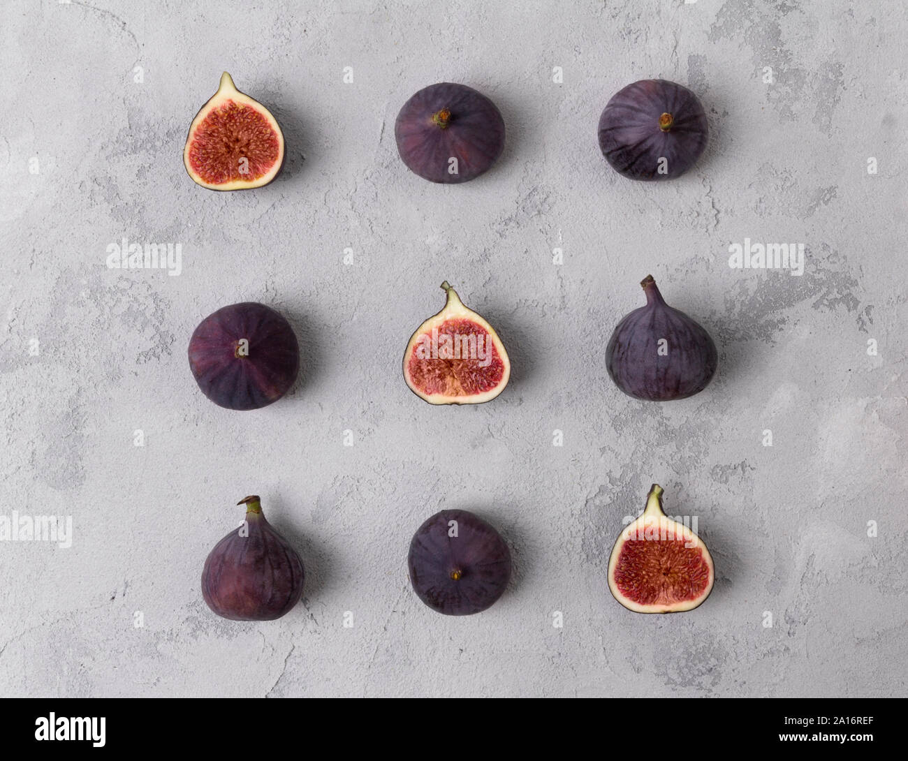 Pattern with fresh ripe figs on a gray concrete background Stock Photo