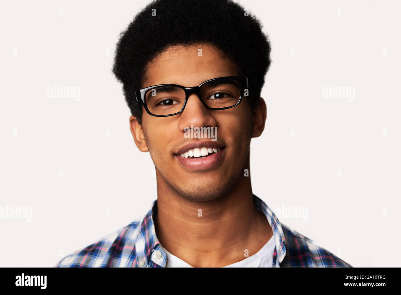 Happy student guy wearing glasses, light background Stock Photo - Alamy