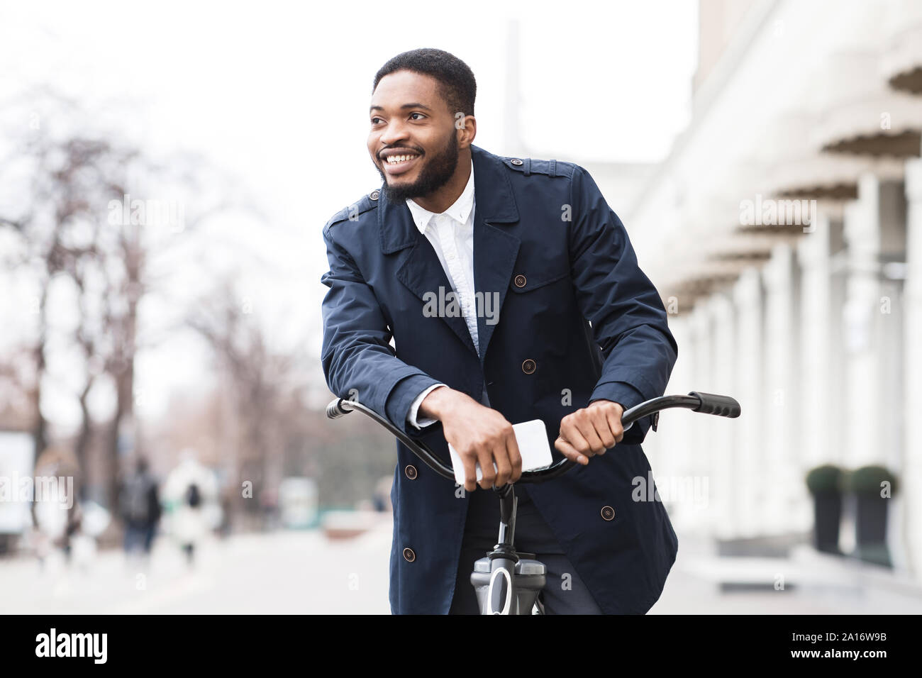 African american man in suit riding on bike to work Stock Photo