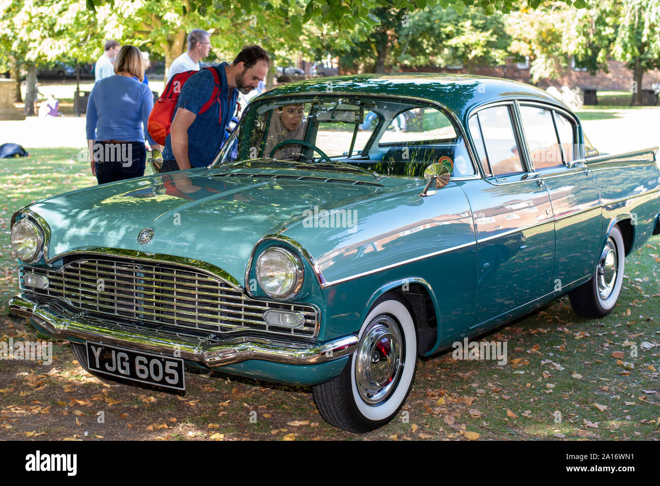 People looking at a classic car on display outside Winchester Cathedral, Winchester, UK Stock Photo