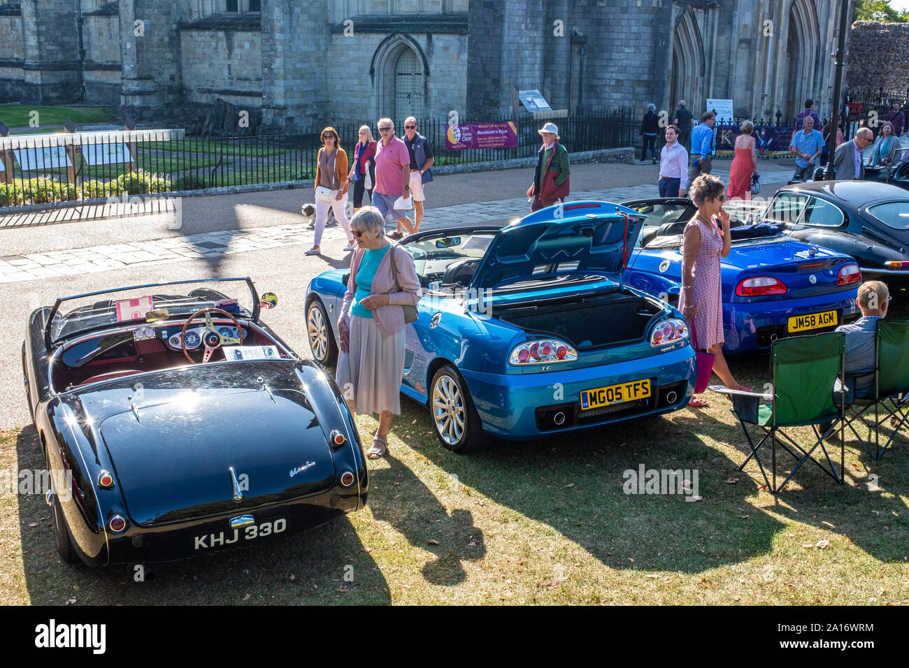People looking at classic cars on display outside Winchester Cathedral, Winchester, UK Stock Photo