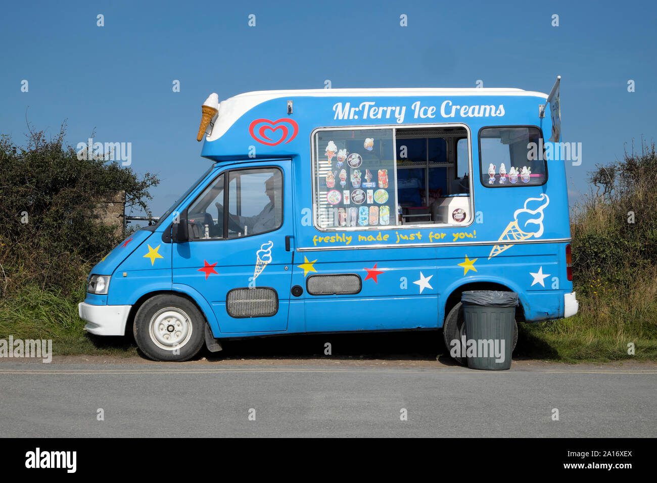 Blue ice cream van exterior view parked on the side of the lane in summer at Martins Haven Marloes Pembrokeshire Wales UK  KATHY DEWITT Stock Photo