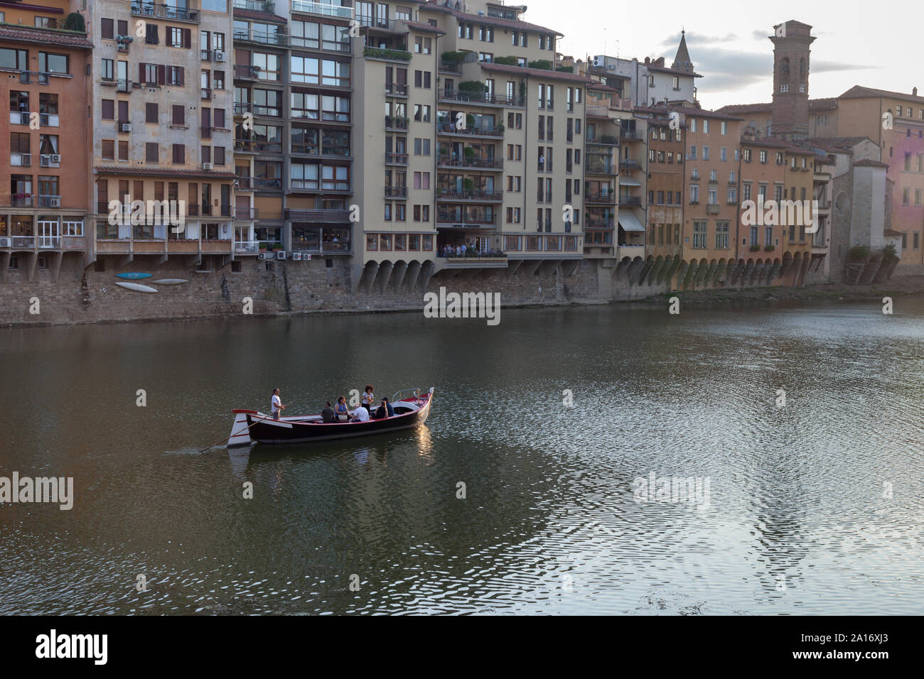 Boaters on Arno River between Ponte Santa Trinita and Ponte Vecchio from Lungarno degli Acciaiuoli at Via Por Santa Maria. Florence, Italy Stock Photo