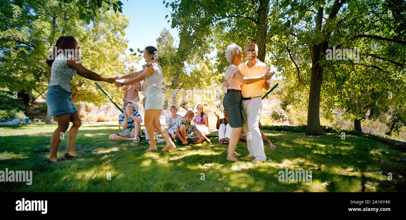 Big family dancing in a park. Stock Photo