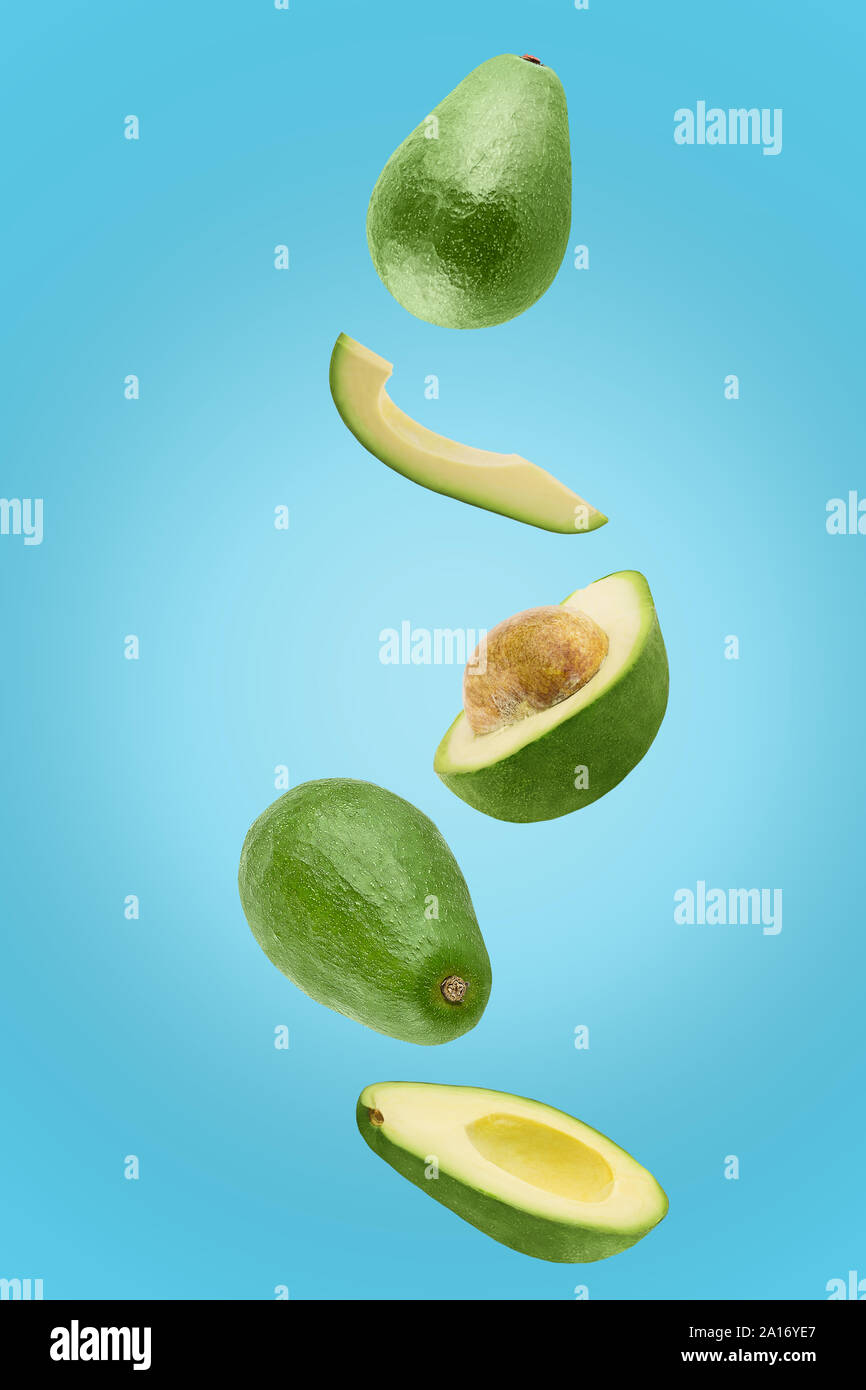 Avocado sliced isolated in blue background viewed from above Stock Photo