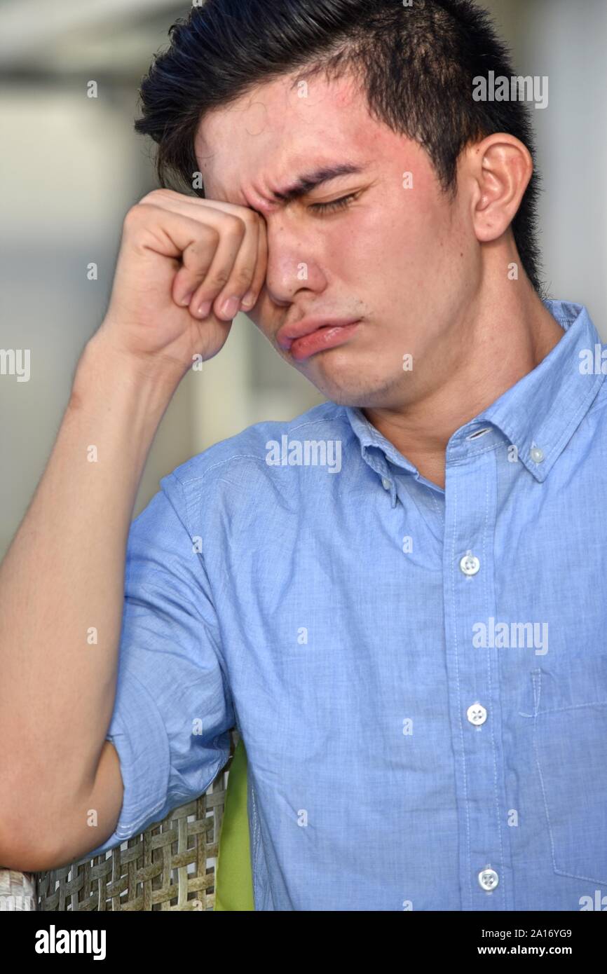 A Tearful Young Asian Male Man Stock Photo