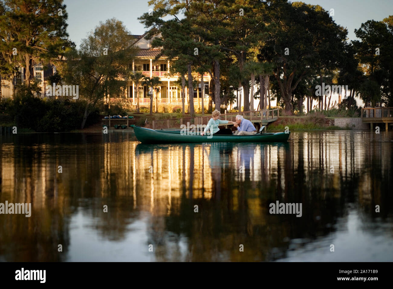 Happy senior couple holding hands while in a canoe. Stock Photo
