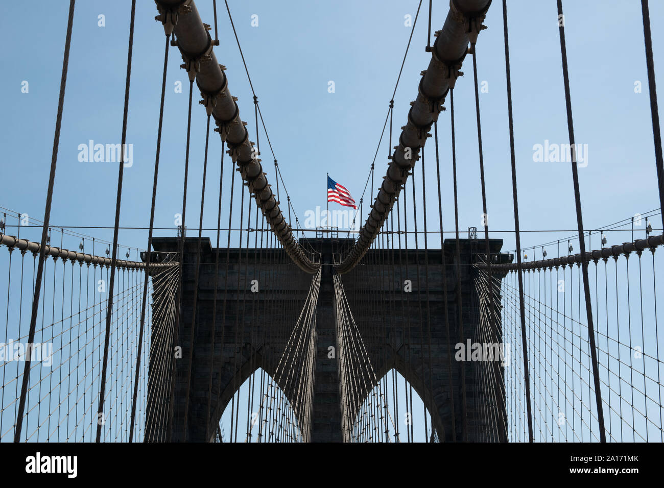 Symmetry of the Brooklyn Bridge with American Flag, Manhattan, New York City, NYC, USA Stock Photo