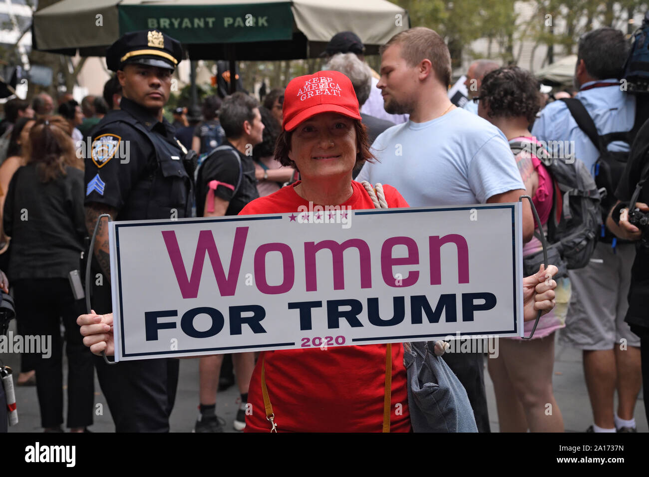 President Trump supporter holding a placard during the Rise and Resist - United in Outrage, a Resistance March along Fifth Avenue. Stock Photo