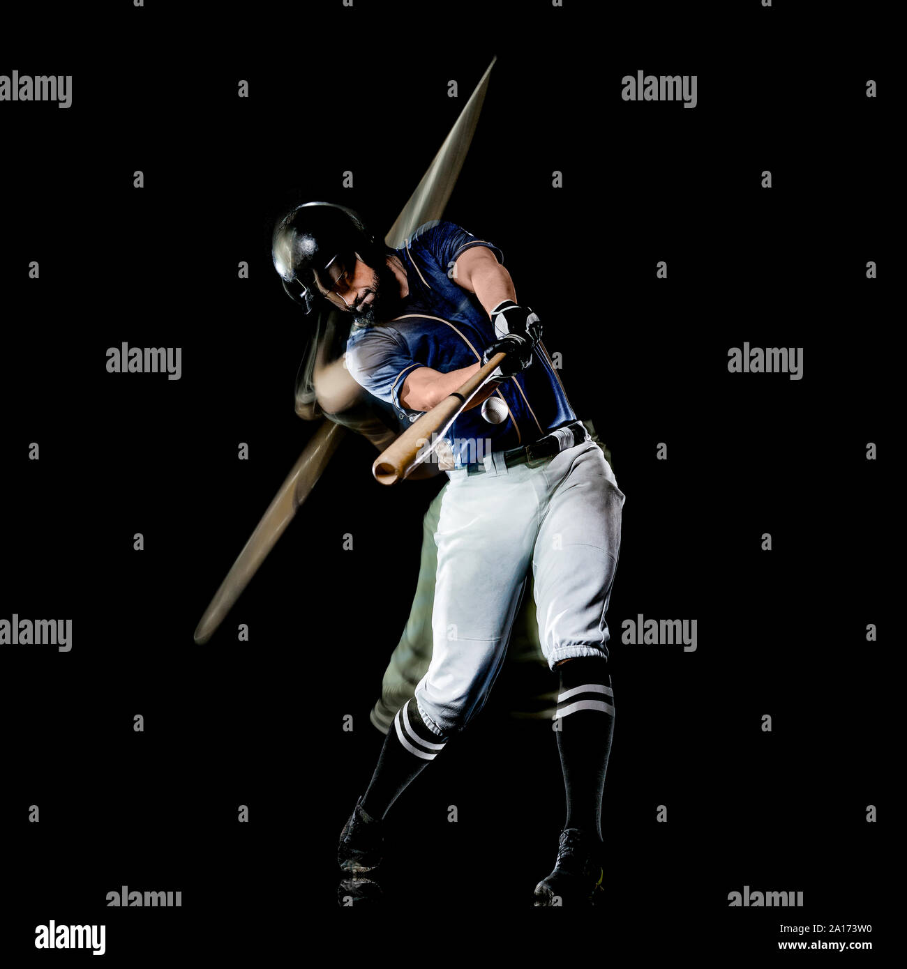 one caucasian baseball player man  studio shot isolated on black background with light painting speed effect Stock Photo