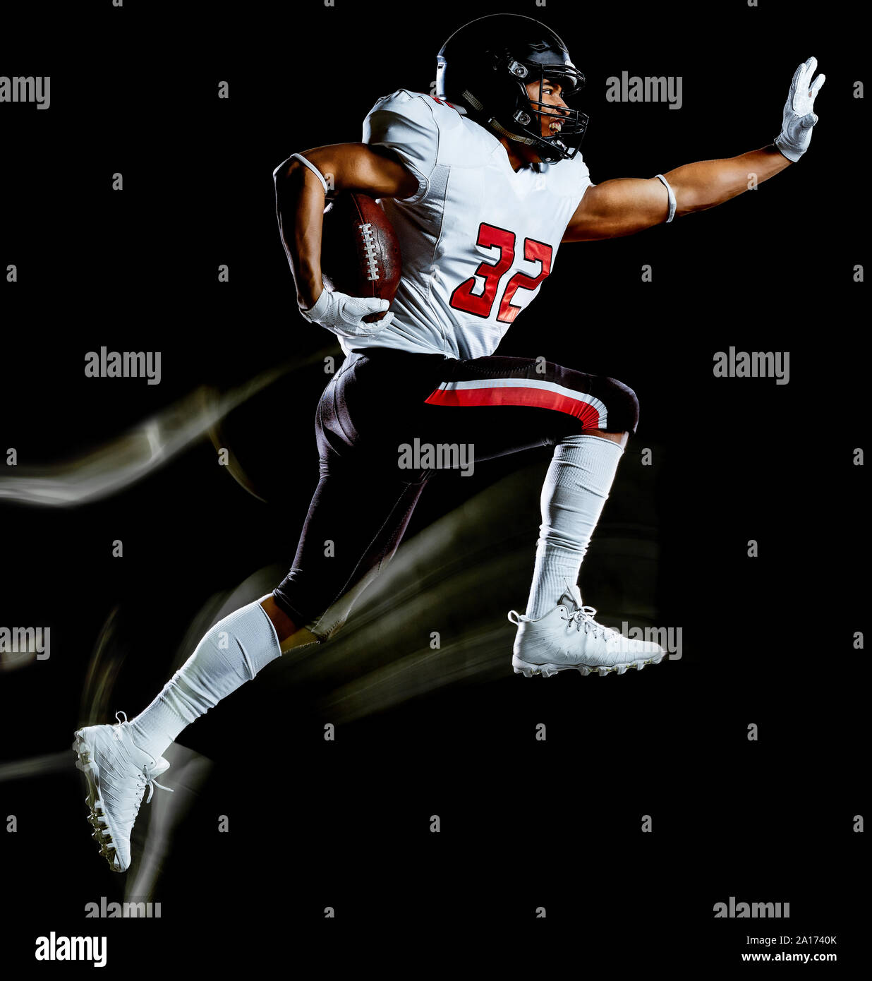 one african american football player man studio shot isolated on black background with light painting with blurred motion speed effect Stock Photo