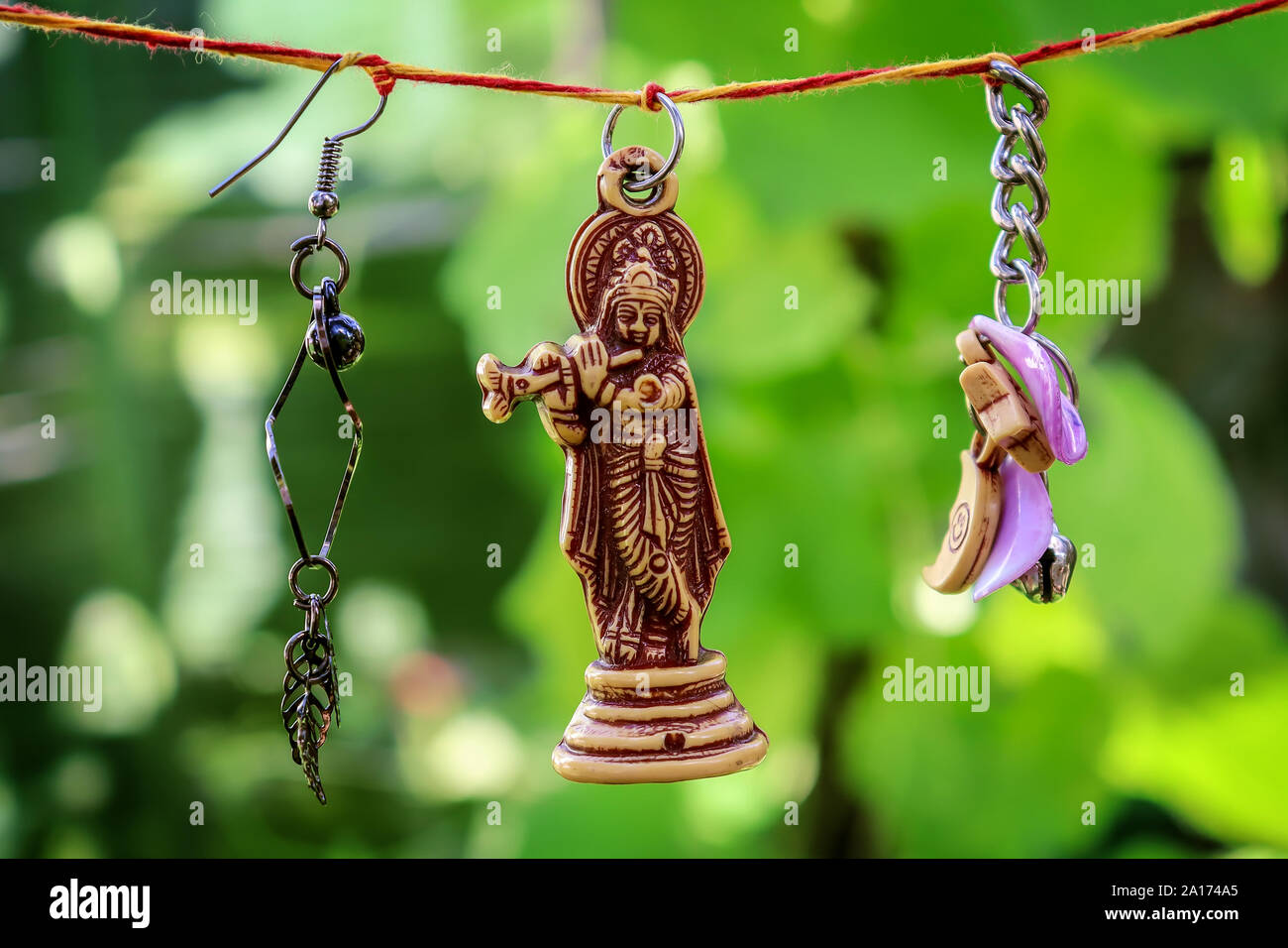 Lord krishna with flute hanging along with decorations on both sides Stock  Photo - Alamy