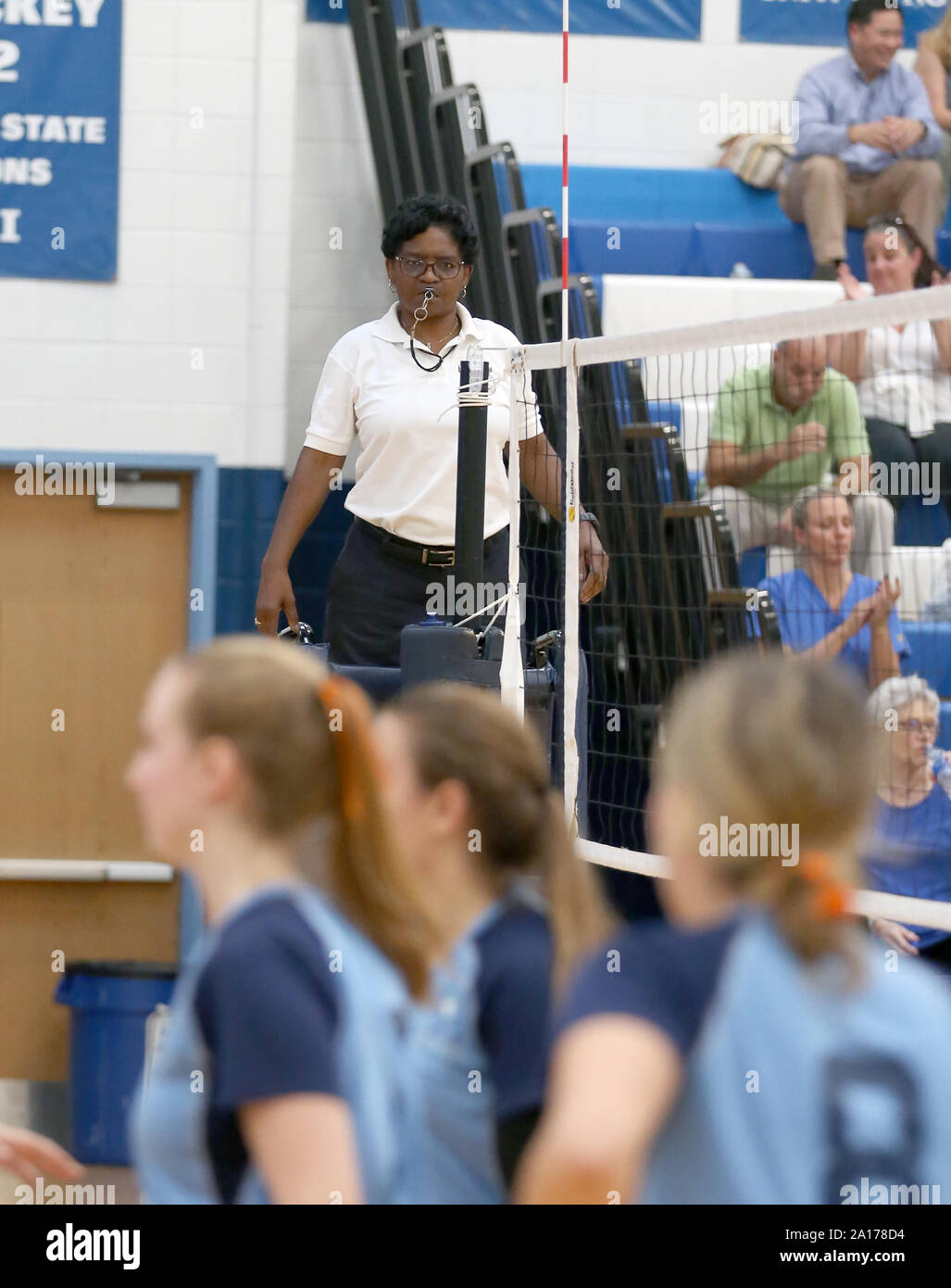 Volleyball referee at a high school game Stock Photo