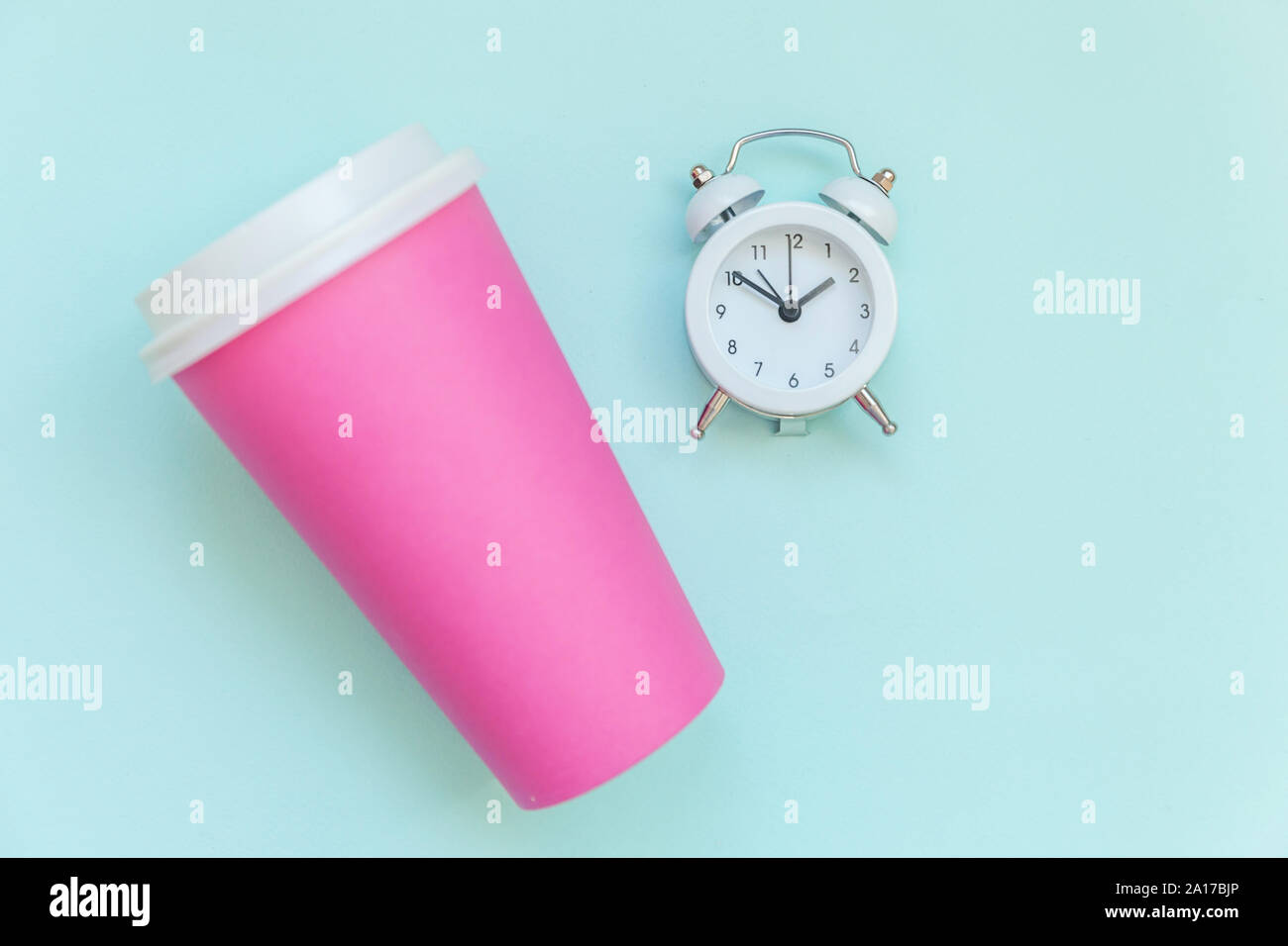 https://c8.alamy.com/comp/2A17BJP/simply-flat-lay-design-pink-paper-coffee-cup-and-alarm-clock-isolated-on-blue-pastel-colorful-background-takeaway-drink-breakfast-beverage-good-morning-wake-up-awake-concept-top-view-copy-space-2A17BJP.jpg