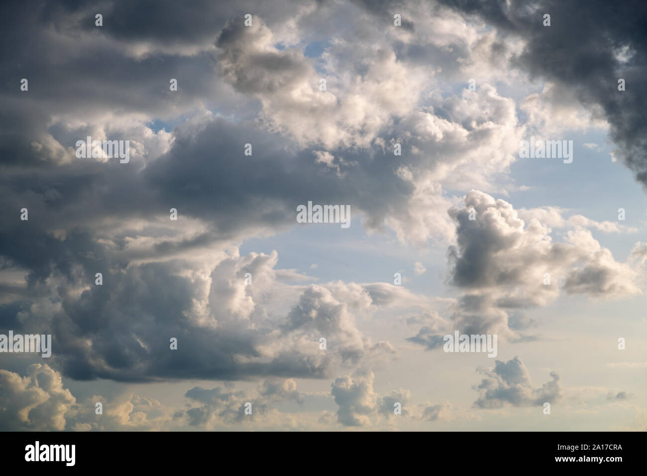 Gray and white clouds in the blue sky above the ground closeup Stock ...
