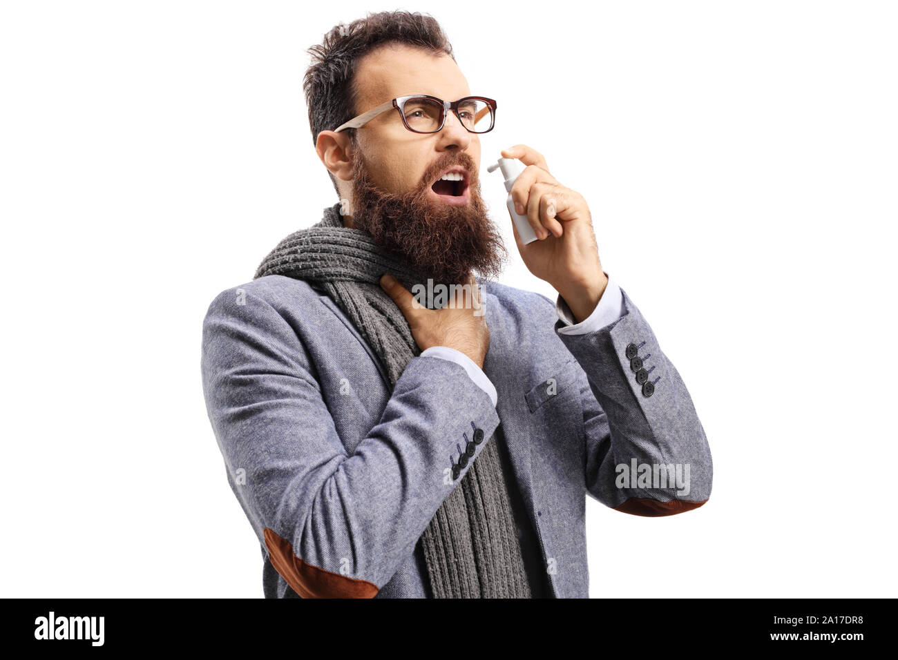 Bearded man with a sore throat spraying a medication isolated on white background Stock Photo