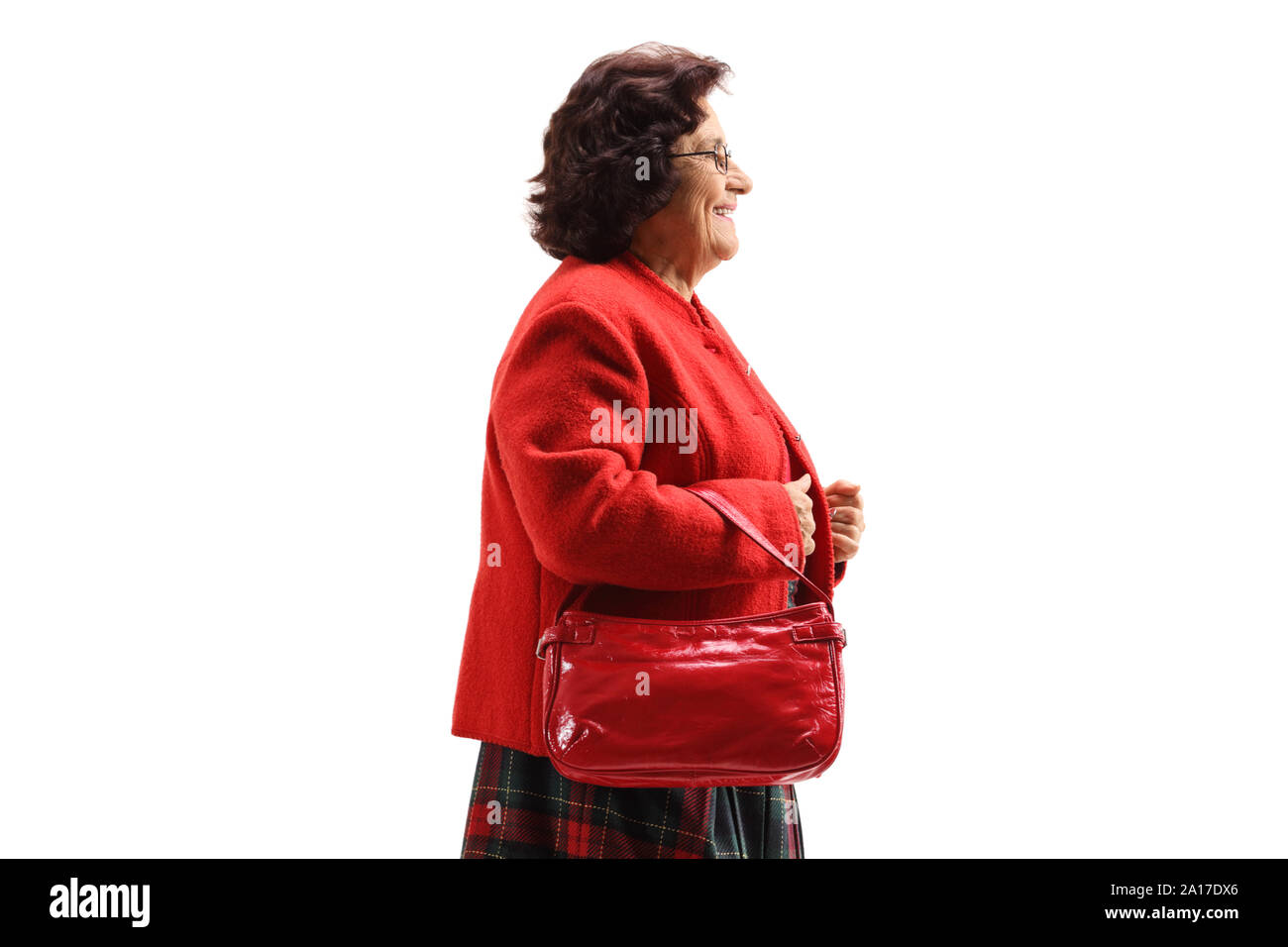 Elderly lady with a red coat walking isolated on white background Stock Photo