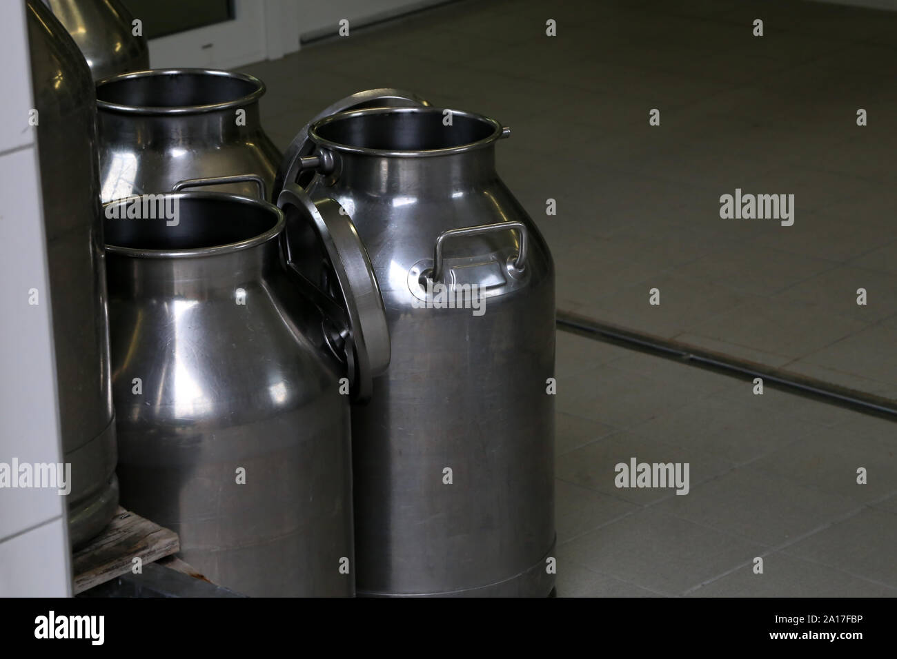 Empty milk flasks stand on the farm Stock Photo