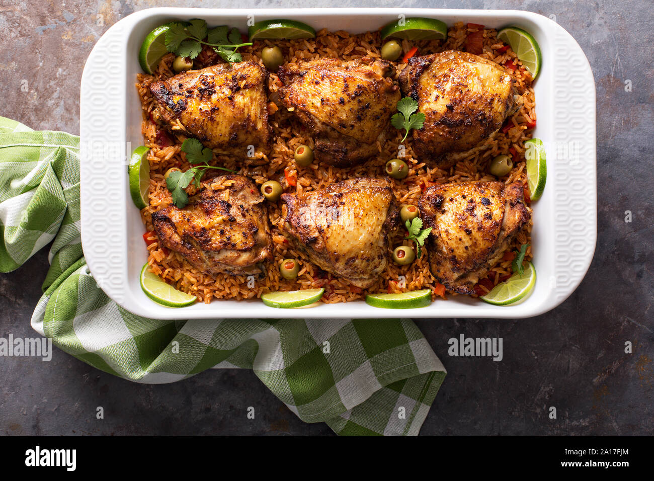 Arroz con pollo, roasted chicken with rice in a baking dish Stock Photo