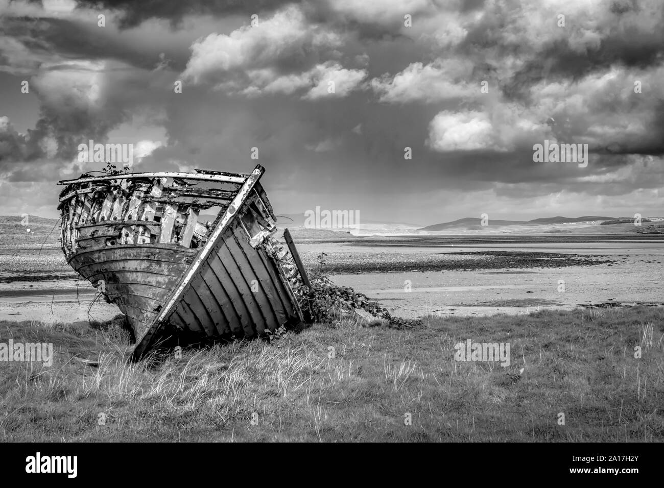 An old wooden Fishing boat decaying on a beach in Donegal Ireland Stock Photo